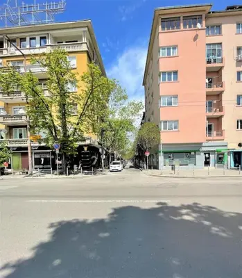 an empty street in a city with a building at Apartment in the Top center next to NDK in Sofia
