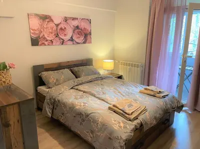 a bedroom with a bed with two towels on it at Apartment in the Top center next to NDK in Sofia