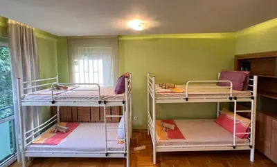 three bunk beds in a room with green walls at Mumbai Spacious 150 Sq M 2BDR near Vitosha BLVD and NDK in Sofia