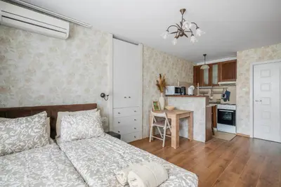a bedroom with a bed and a kitchen at Vitosha Boulevard Studio in Sofia