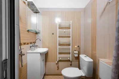 a small bathroom with a toilet and a sink at Vitosha Boulevard Studio in Sofia