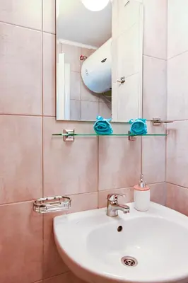 a bathroom with a white sink and a mirror at Studio 19 in Sofia