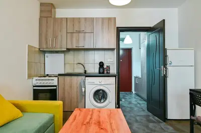 a kitchen with a washing machine in the middle of a room at Studio 19 in Sofia