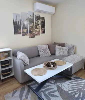 a living room with a couch and a table at apartment Serenity, Bansko in Bansko