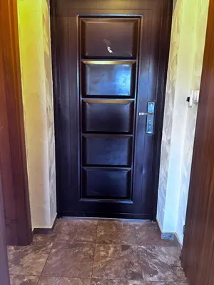 a black door with empty shelves in a hallway at кристален въздух in Sofia