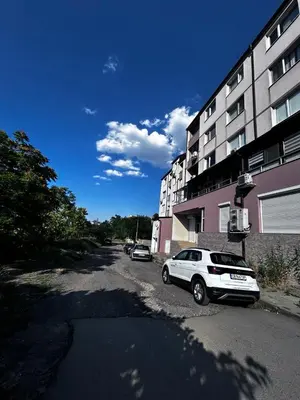 a white car parked in front of a building at кристален въздух in Sofia