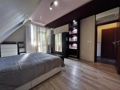 a bedroom with a large bed and a staircase at кристален въздух in Sofia