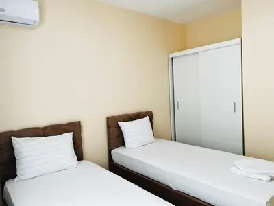 two beds in a room with a mirror at Cherry Apartment with 2 bedrooms in Sofia