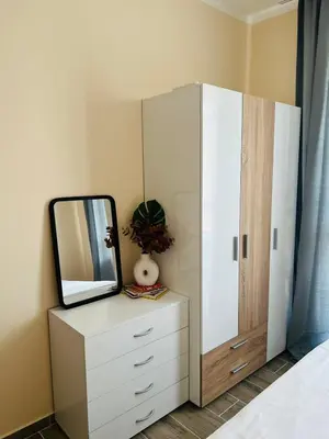 a mirror on a dresser next to a cabinet at Strаwberry Apartment in Sofia