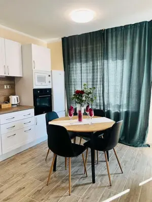 a kitchen with a table and chairs with flowers on it at Strаwberry Apartment in Sofia