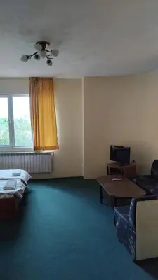 a living room with a couch and a table at Интернационал in Kulata