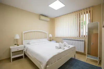a bedroom with a white bed and a window at Bright 1BDR Apartment in Top Center in Sofia