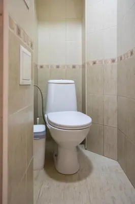 a bathroom with a white toilet in a room at Bright 1BDR Apartment in Top Center in Sofia
