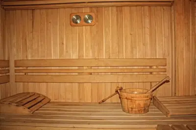 a sauna with a bucket on the floor and a bench at Predela 1 Bansko Apartment in Bansko