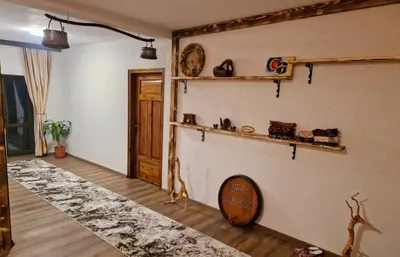 a room with a wall with shelves and a table at Вила Леска in Leska