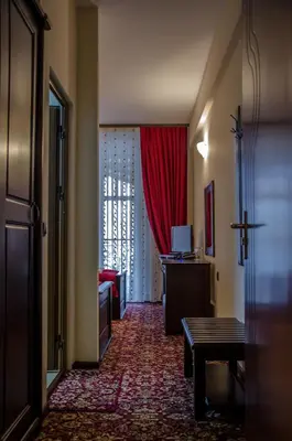 a hallway with a living room with a red curtain at Rubis Hotel in Rudozem