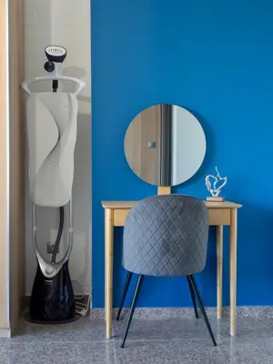 a table with a chair next to a mirror at Vertigo 2 Modern 2-Bedroom Apartment with Parking & Vitosha View in Sofia