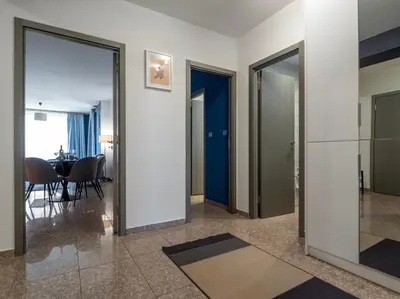 a hallway with glass doors and a dining room at Vertigo 2 Modern 2-Bedroom Apartment with Parking & Vitosha View in Sofia