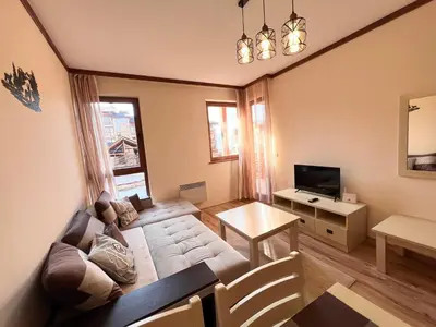 a living room with a couch and a table at Apartment Saint Ivan Ski Resort in Bansko