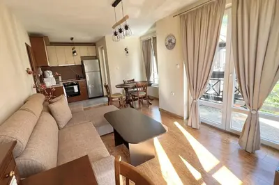 a living room with a couch and a table at Bojurland Apartment, Bansko in Bansko