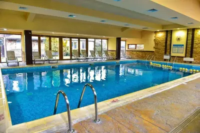 a large swimming pool in a hotel room at Bojurland Apartment, Bansko in Bansko