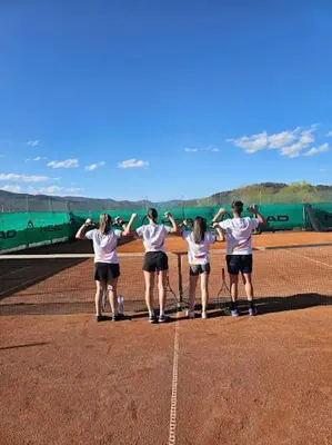 a group of people standing on a tennis court at City Apartments 4 in Velingrad