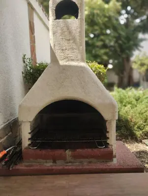 a stone pizza oven sitting on the side of a building at Lea Hause with swimming pool,Jacuzzi in Vitosha montain and free parking in Sofia