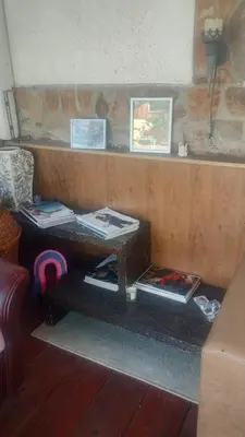 a table with books on it in a living room at Lea Hause with swimming pool,Jacuzzi in Vitosha montain and free parking in Sofia