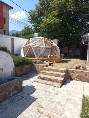 a large wooden building with stairs in a yard at Lea Hause with swimming pool,Jacuzzi in Vitosha montain and free parking in Sofia