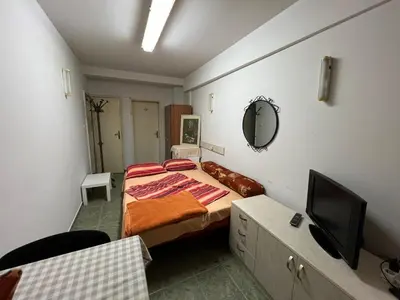 a small bedroom with a bed and a tv at Cheep&Free on the Ground floor and Pets friendly in Sofia