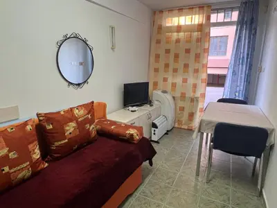 a room with a couch and a tv and a mirror at Cheep&Free on the Ground floor and Pets friendly in Sofia
