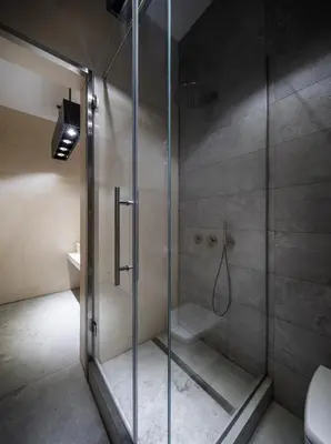 a shower with a glass door in a bathroom at The Nest by Juno Hotel Sofia in Sofia