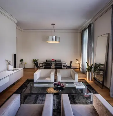 a living room with a couch and a table at The Nest by Juno Hotel Sofia in Sofia