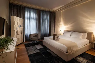 a bedroom with a large white bed and a window at The Nest by Juno Hotel Sofia in Sofia
