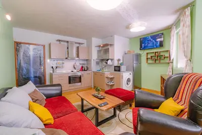a living room with a couch and a table at Sofia Centre with Free on-site Parking in Sofia