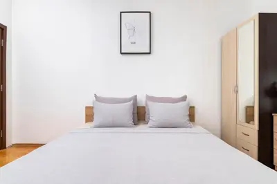 a bedroom with a white bed with two pillows at Black Peak Panorama central apartment in Sofia