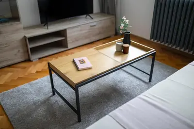 a coffee table in a living room with a television at Black Peak Panorama central apartment in Sofia