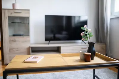 a coffee table in a living room with a tv at Black Peak Panorama central apartment in Sofia