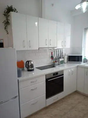 a kitchen with white cabinets and a stove top oven at Cathedral Central Apartment Top Location in Sofia