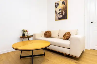 a living room with a couch and a table at Happy People Plovdiv 1-BD Apartment - White by Flat Mаnager in Plovdiv