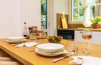 a wooden table with glasses of wine on it at Happy People Plovdiv 1-BD Apartment - White by Flat Mаnager in Plovdiv