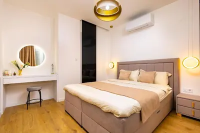 a bedroom with a large bed and a mirror at Happy People Plovdiv 1-BD Apartment - White by Flat Mаnager in Plovdiv