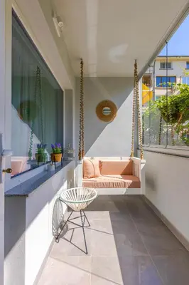 a porch with a swing and a chair at Happy People Plovdiv 1-BD Apartment - White by Flat Mаnager in Plovdiv