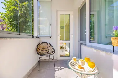 a balcony with a glass table and a chair at Happy People Plovdiv 1-BD Apartment - White by Flat Mаnager in Plovdiv