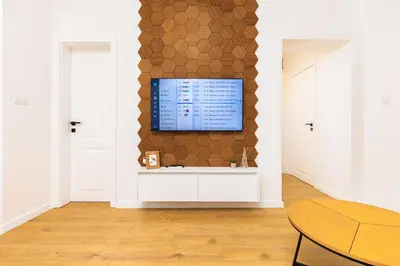 a living room with a tv on a wall at Happy People Plovdiv 1-BD Apartment - White by Flat Mаnager in Plovdiv