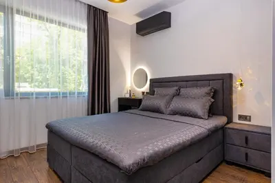 a bedroom with a large bed and a window at Happy People Plovdiv - Grey 1-BD Apartment by Flat Mаnager in Plovdiv