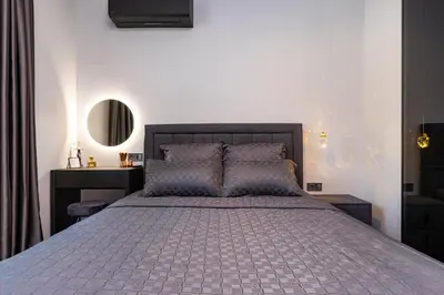 a bedroom with a large bed and a mirror at Happy People Plovdiv - Grey 1-BD Apartment by Flat Mаnager in Plovdiv