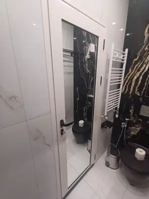 a bathroom with a toilet and a mirror at Luxurious House with Deluxe rooms & Free Secured Parking in Sofia