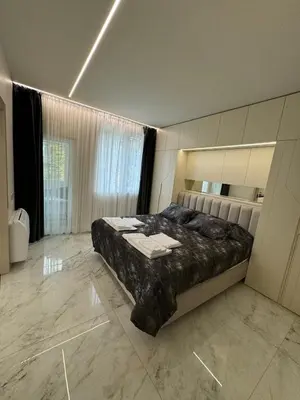 a bedroom with a large bed and a large window at Luxurious House with Deluxe rooms & Free Secured Parking in Sofia