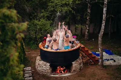 a group of people standing around a fire pit at Вила Княжеска баня in Sofia